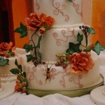 bruidstaart met gumpaste herfst bloemwerk en bijpassende minitaartjes